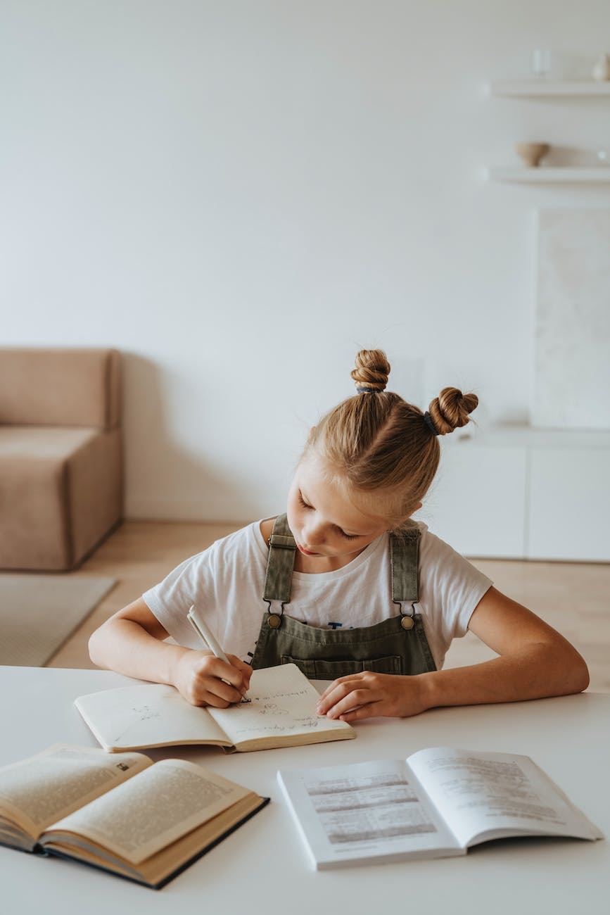 little girl writing on a notebook