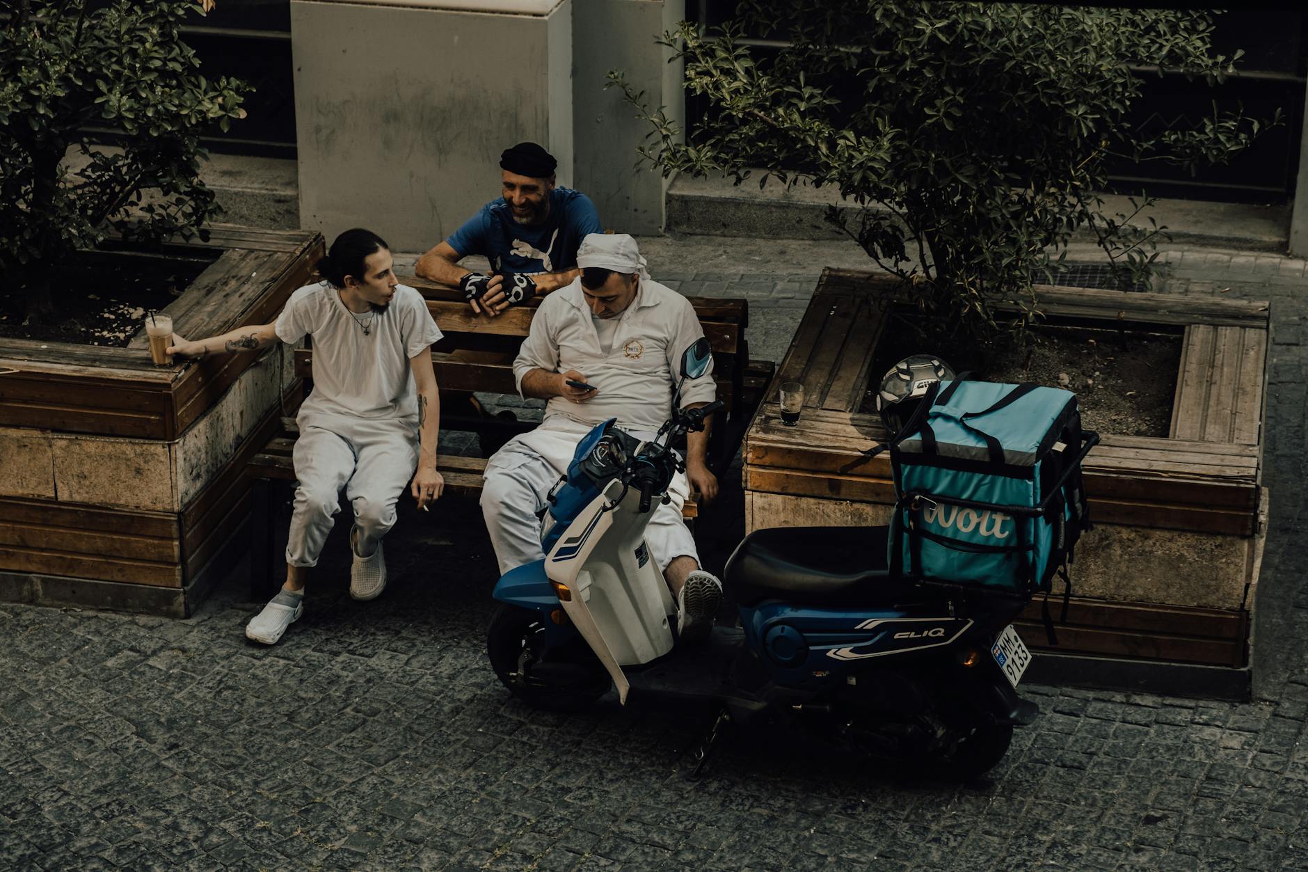 men working in food delivery on a street